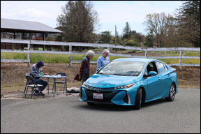 light blue electric car at checkpoint